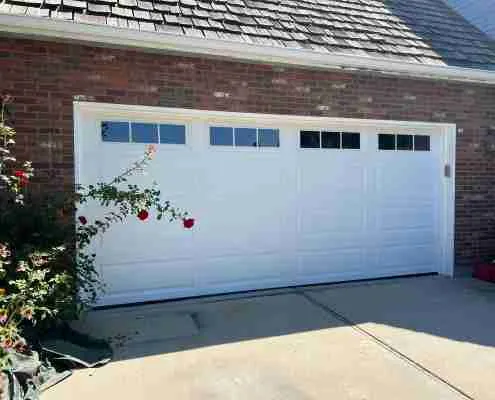New white garage door with windows after installation