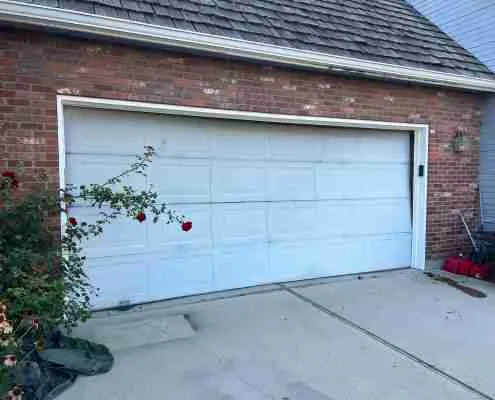 Old white garage door before replacement